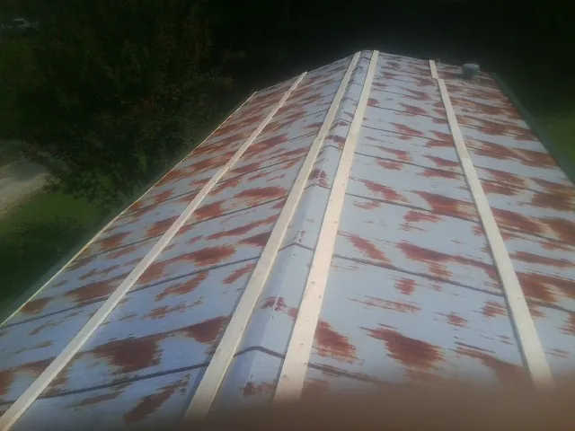 Rusted metal roof panels with new wood purlins before replacement — Storm Damage Roof Repair in Wyckoff by Roofing Brothers