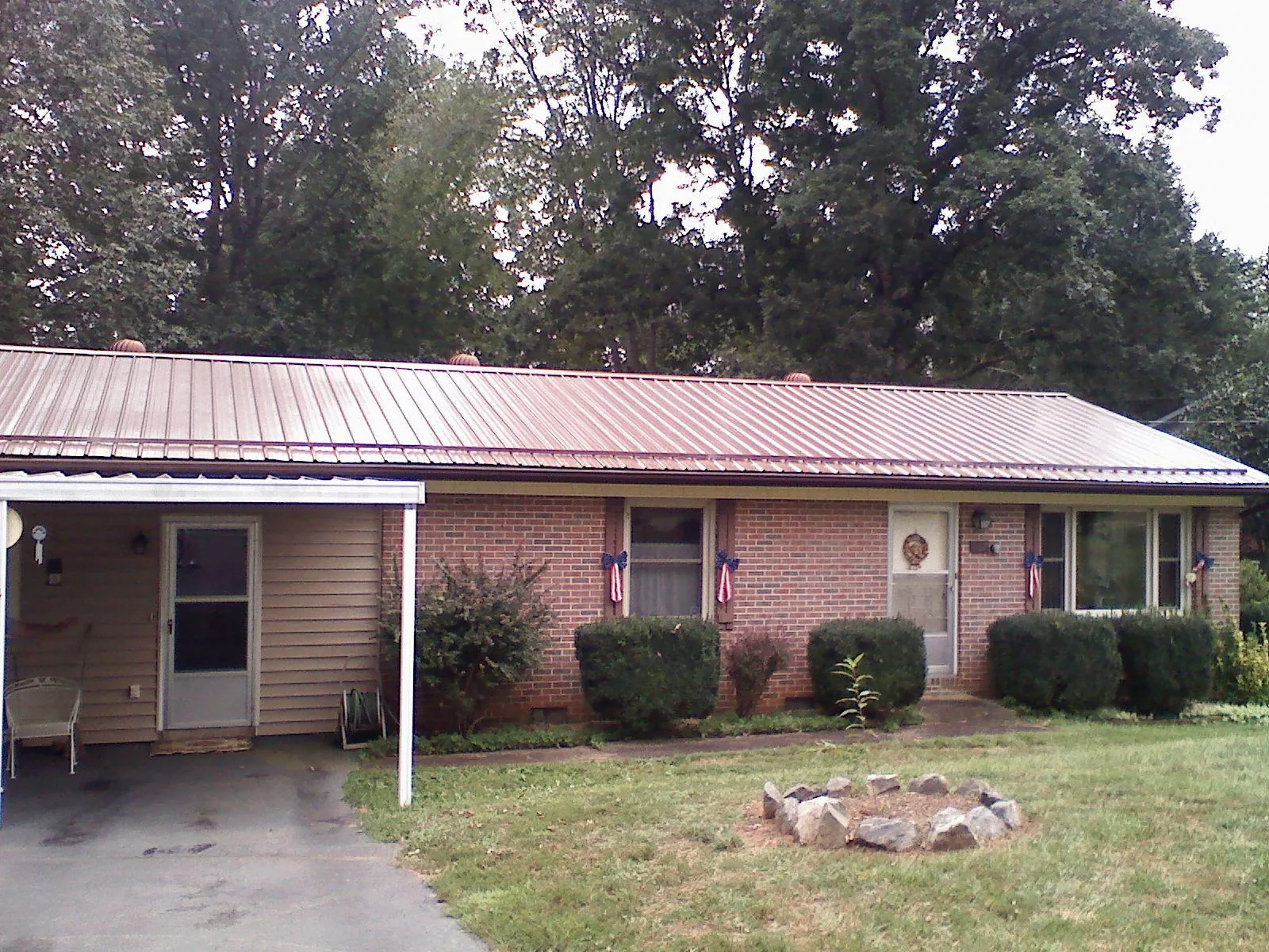 Bronze metal roof and carport on a brick ranch home — Roof Repair work by our crew in Wyckoff